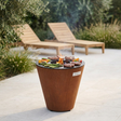 Arteflame ONE20 used as a grill with steak and vegetables cooking on its flat-top ring