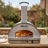 Bull pizza oven in an outdoor kitchen with a pizza baking inside