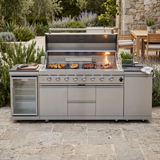 Grill island in action with the lid open, burners lit, and food cooking on the grates
