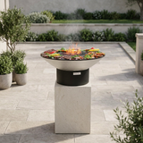 Grill on its tall stone pedestal in an outdoor setting, without the person