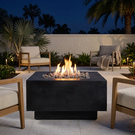 Ignited Cubo fire bowl with lounge chairs on a Florida winter night