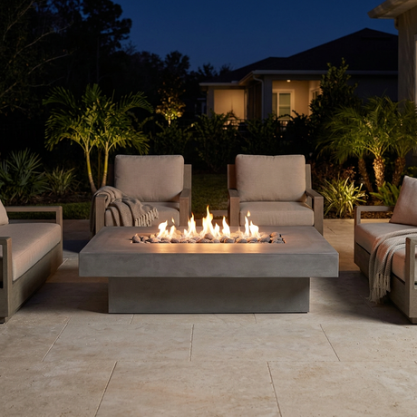 Ignited Toplina fire pit with surrounding lounge chairs on a cool Florida winter night