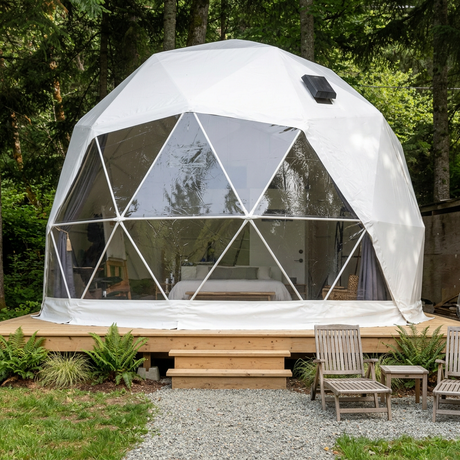Patioza 16-foot Phoenix dome in a landscaped woodland setting