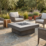 Photorealistic lifestyle image of the Platz square concrete fire pit table in a styled outdoor patio setting