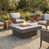 Photorealistic lifestyle image of the Platz square concrete fire pit table with a natural flame burning in the burner pan