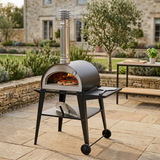 Pizzi pizza oven baking a pizza with a glowing wood fire on an outdoor terrace
