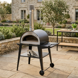 Pizzi wood-fired pizza oven styled on a natural stone garden terrace