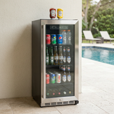 Stocked outdoor refrigerator against a house wall with a pool terrace beyond