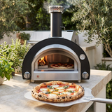 Summerset oven in use with freshly baked margherita pizza on a stone patio countertop
