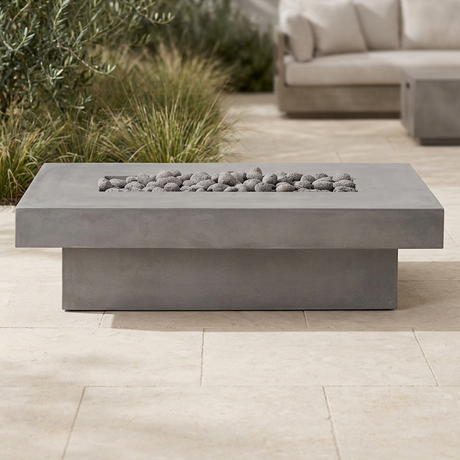 Toplina fire pit table in a naturally styled stone patio setting