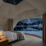 View from inside the dome overlooking a snowy lake beneath the stars